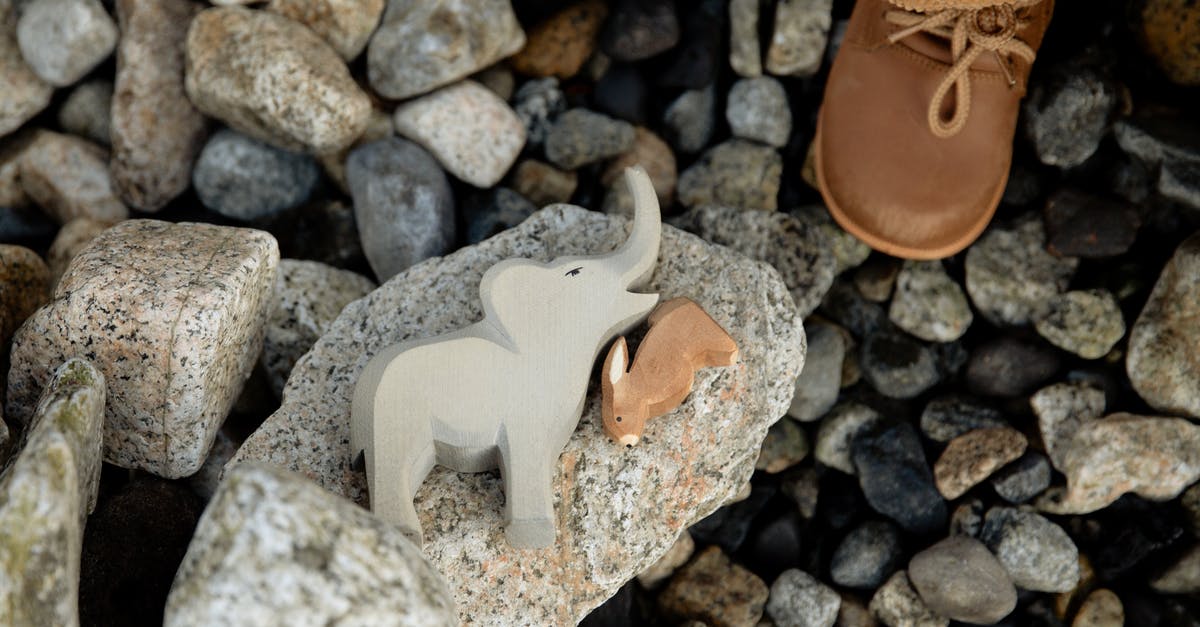 Can I spawn baby rabbits? - Faceless child playing with animal toys on rocky coast Can I spawn baby rabbits? - Faceless child playing with animal toys on rocky coast