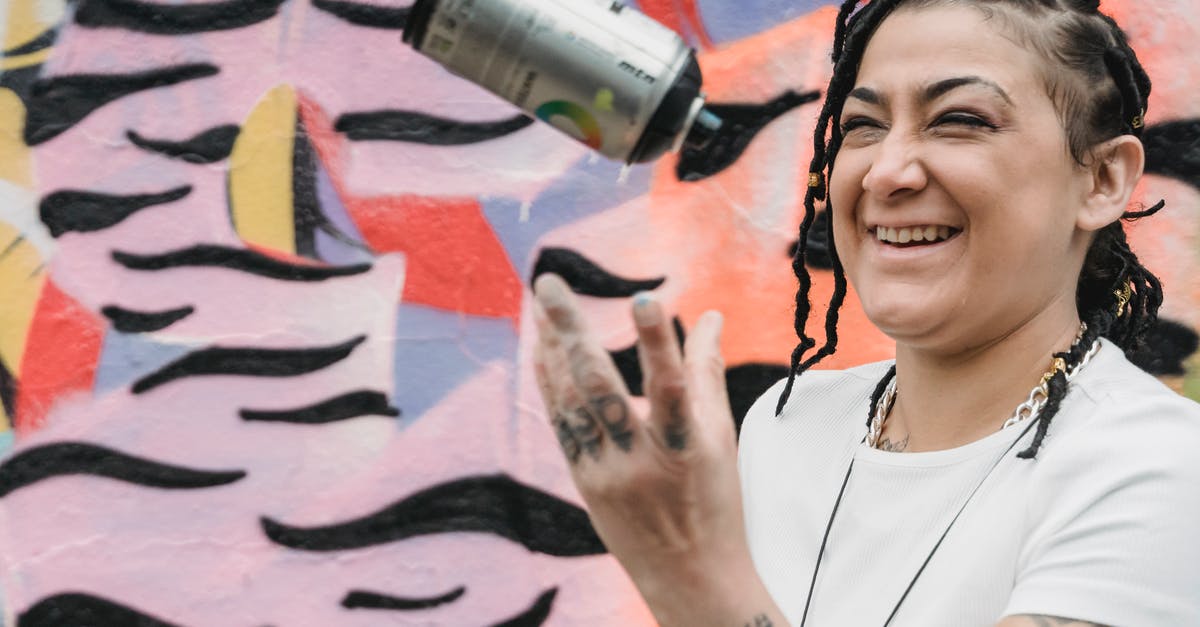 Can I supply sectors with strategic resources? - Happy ethnic female artist with braided hair tossing up spray paint can while standing near wall with creative graffiti on street Can I supply sectors with strategic resources? - Happy ethnic female artist with braided hair tossing up spray paint can while standing near wall with creative graffiti on street