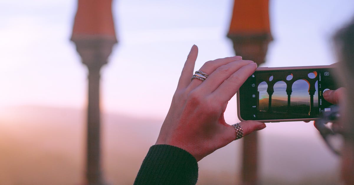 Can I take The Castle without doing the quest? - Crop unrecognizable female traveler taking photo of old oriental castle with arched passage on mobile phone against sunset sky