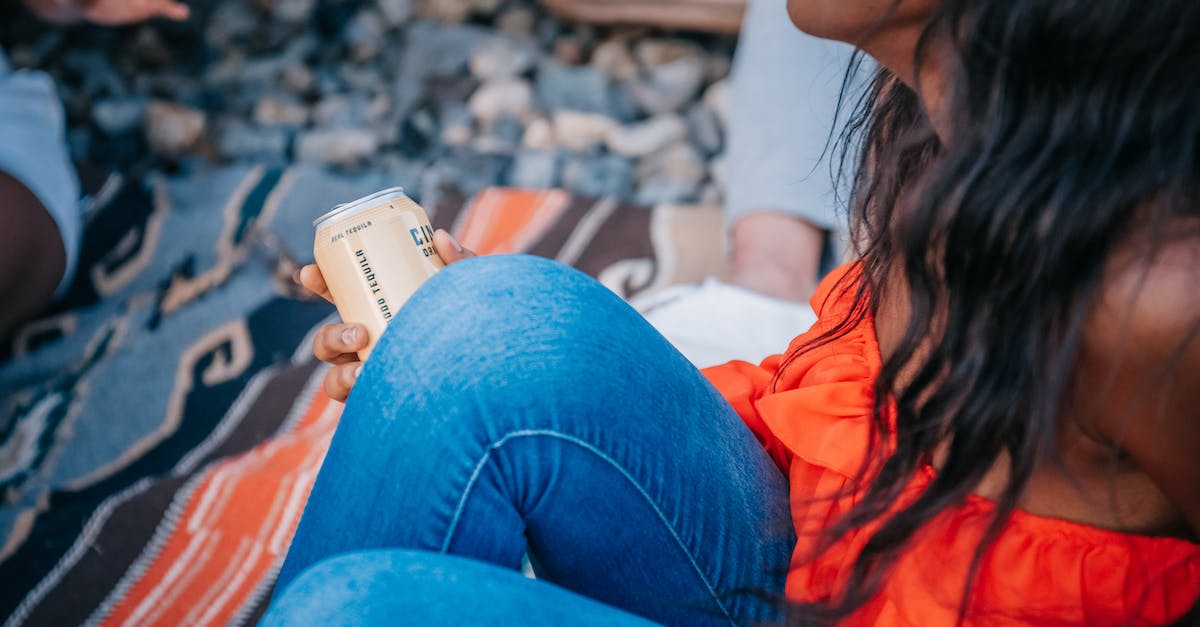 Can I talk to people without digging up their past? - Woman in Orange Top Holding a Can
