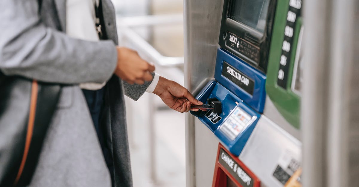 Can I transfer money to another player on GTA V online? - Side view of crop unrecognizable female in stylish clothes using credit card while buying metro ticket via electronic machine