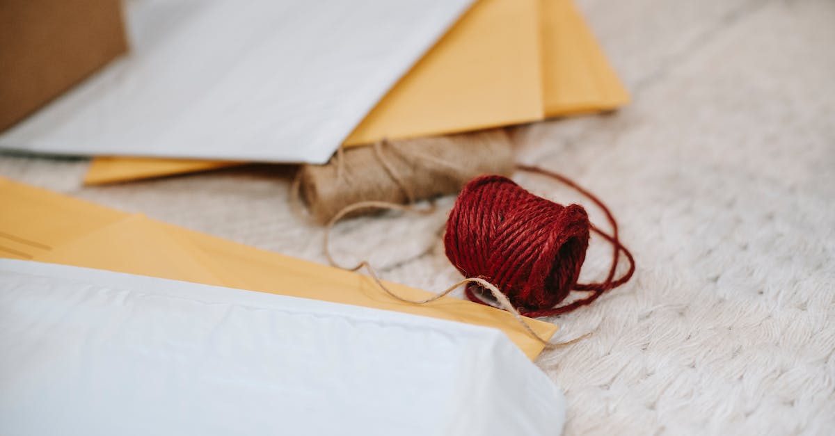 Can I uncraft items with logistic pipes? - Woolen red and beige twine thread bobbins among envelopes