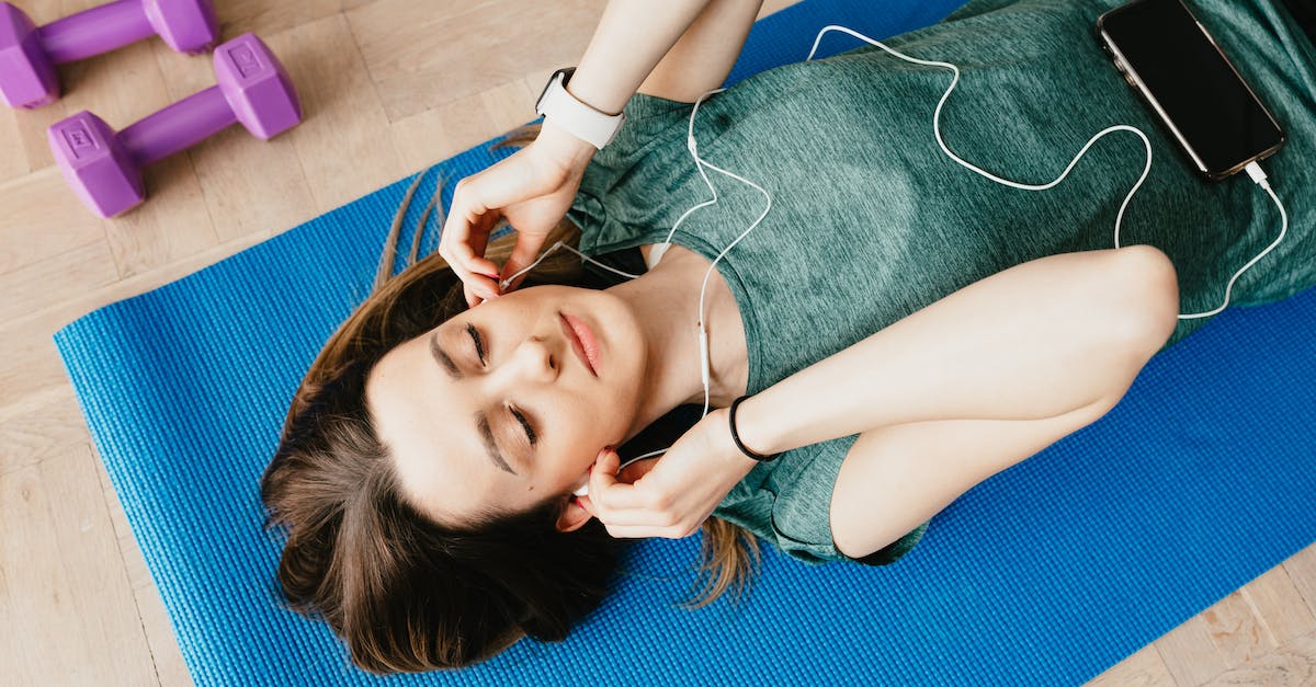 Can I use a removable hard drive from a normal Xbox 360 on a slim model? [closed] - Sportive lady in earphones listening to music chilling on mat