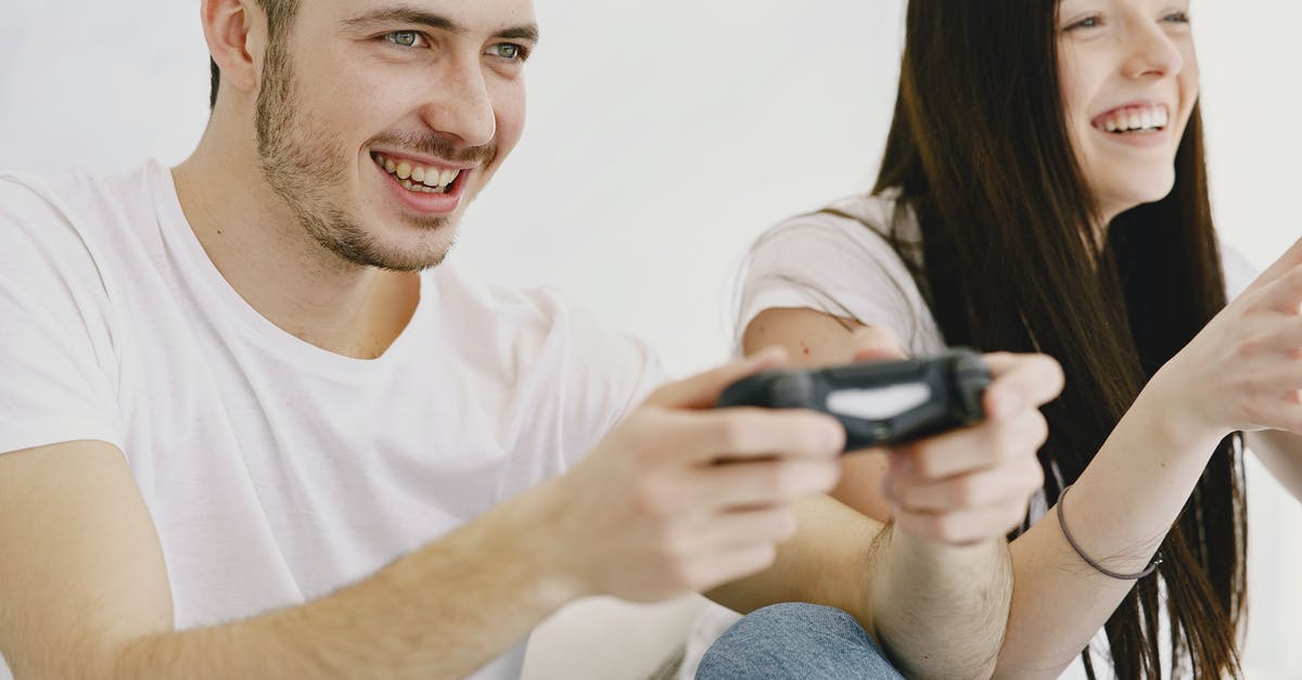 Can I use my friend's PlayStation Plus account to get discounts on my account? - Crop cheerful couple enjoying while playing videogame at home Can I use my friend's PlayStation Plus account to get discounts on my account? - Crop cheerful couple enjoying while playing videogame at home