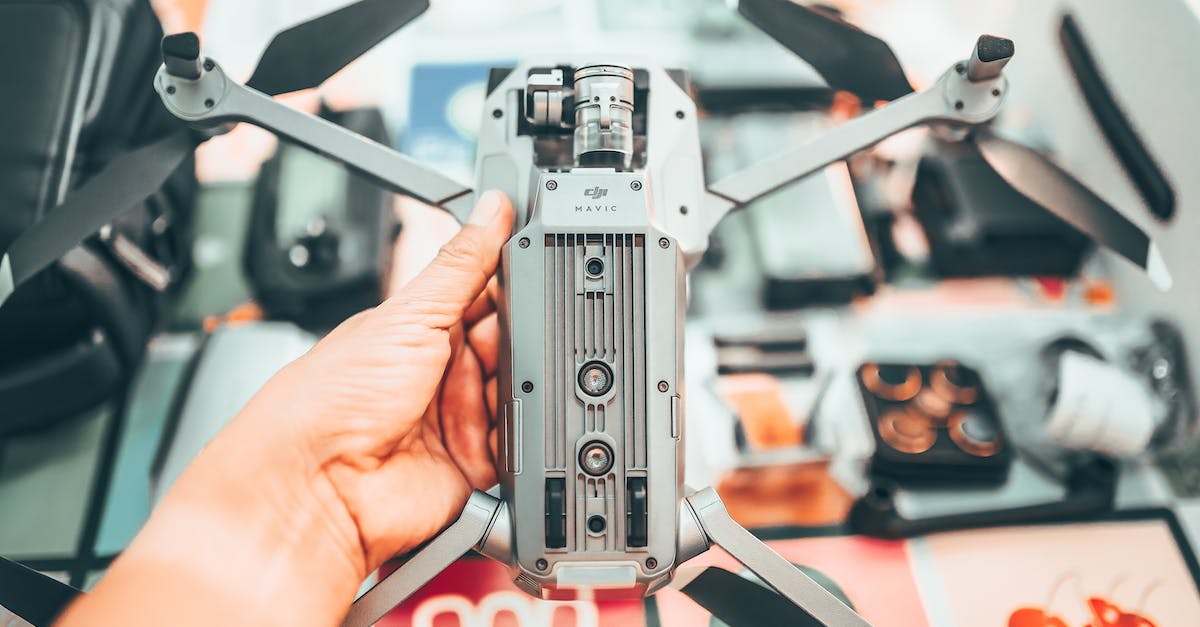 Can I use my PS3 remote control on my PS4 - Unrecognizable photographer checking drone with camera