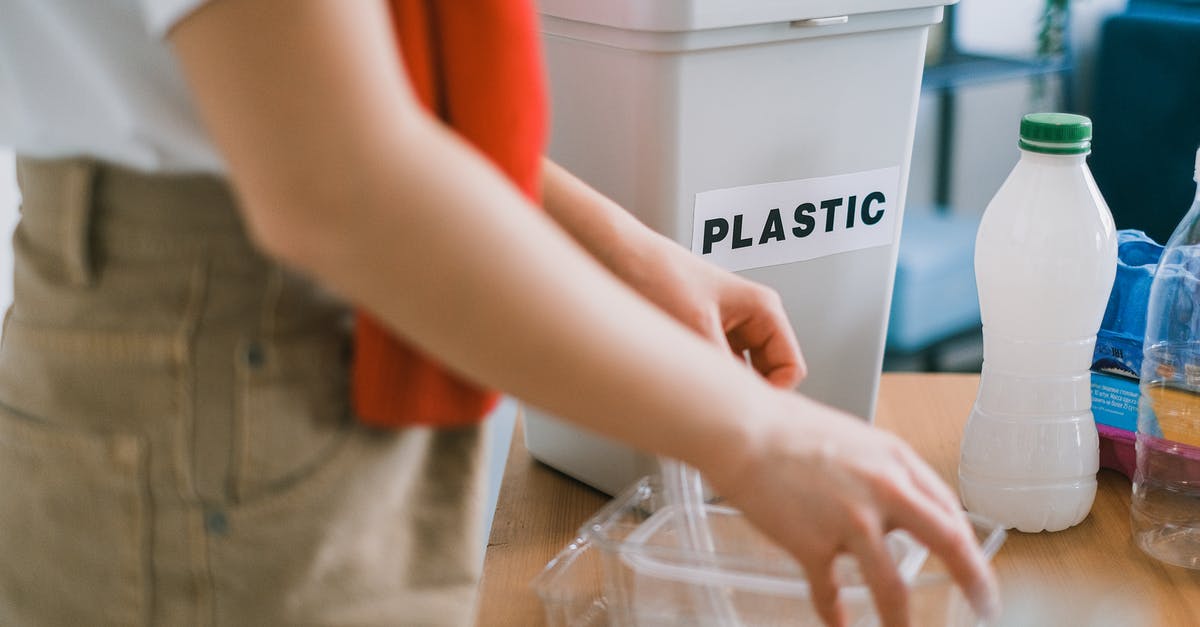 Can I use Pokemon Home to sort my boxes permanently - Crop anonymous female in casual clothes standing near bucket for plastic and sorting out rubbish in light room