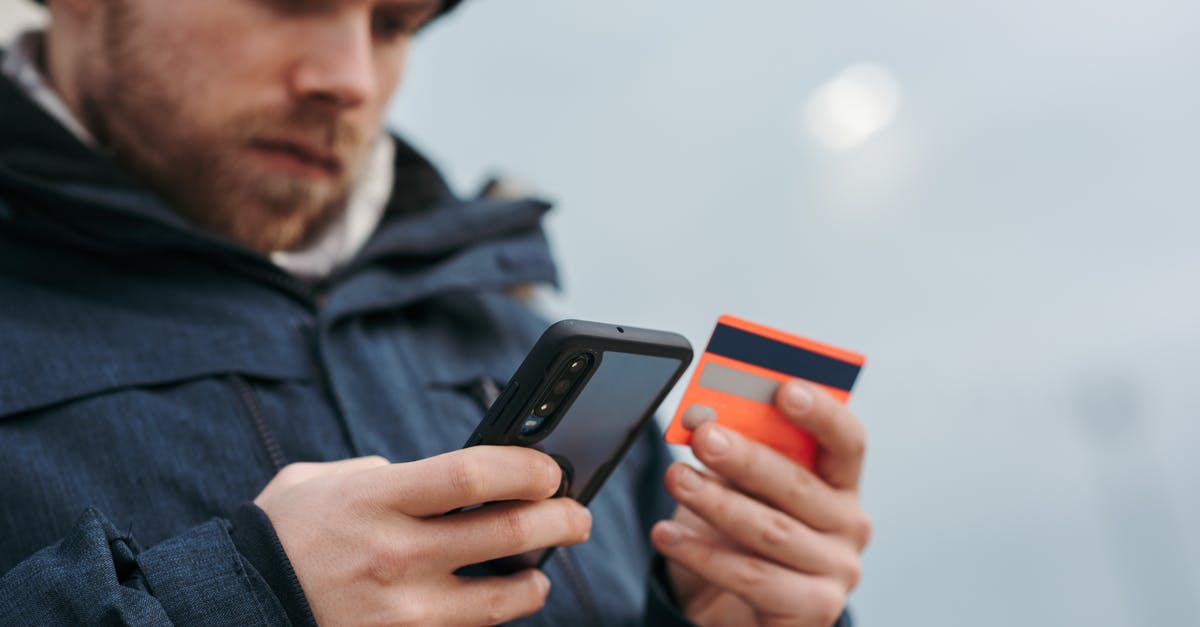 Can I use previously not selected perks in the punch card machine? - Serious man paying online purchases using smartphone on street