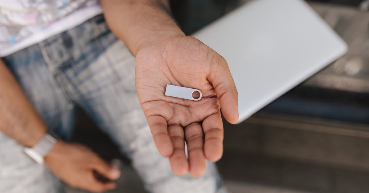 Can I use previously not selected perks in the punch card machine? - From above crop male in casual outfit sitting on street bench with laptop and demonstrating flashcard on hand