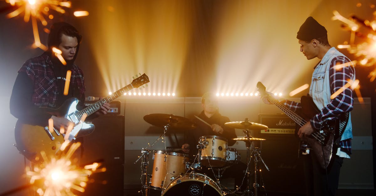 Can I use PS2-to-WII adapters for Guitar Hero, Rock Band, Dance Dance Revolution? - Man Playing Guitar on Stage Can I use PS2-to-WII adapters for Guitar Hero, Rock Band, Dance Dance Revolution? - Man Playing Guitar on Stage