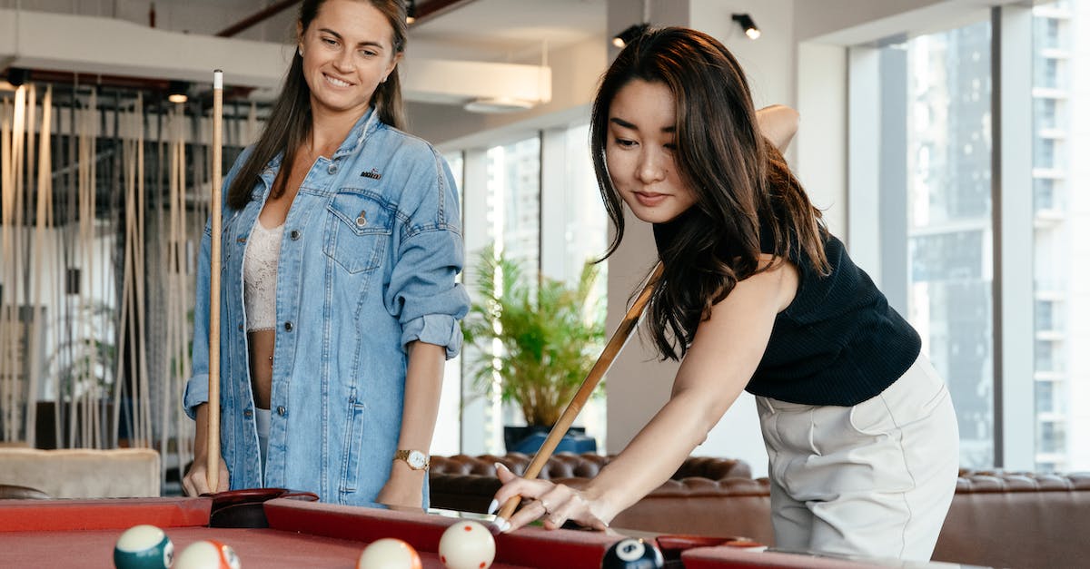 Can Karthus' Ult Hit Fizz During Playful Trickster? - Positive diverse women in casual clothes playing billiard together in spacious room in club in daytime