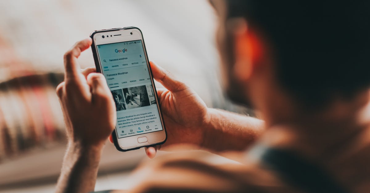 Can Necromactic Scroll and Papyrus Scarab be used at the same time? - Back view of crop anonymous young male reading news on mobile phone while sitting in bedroom