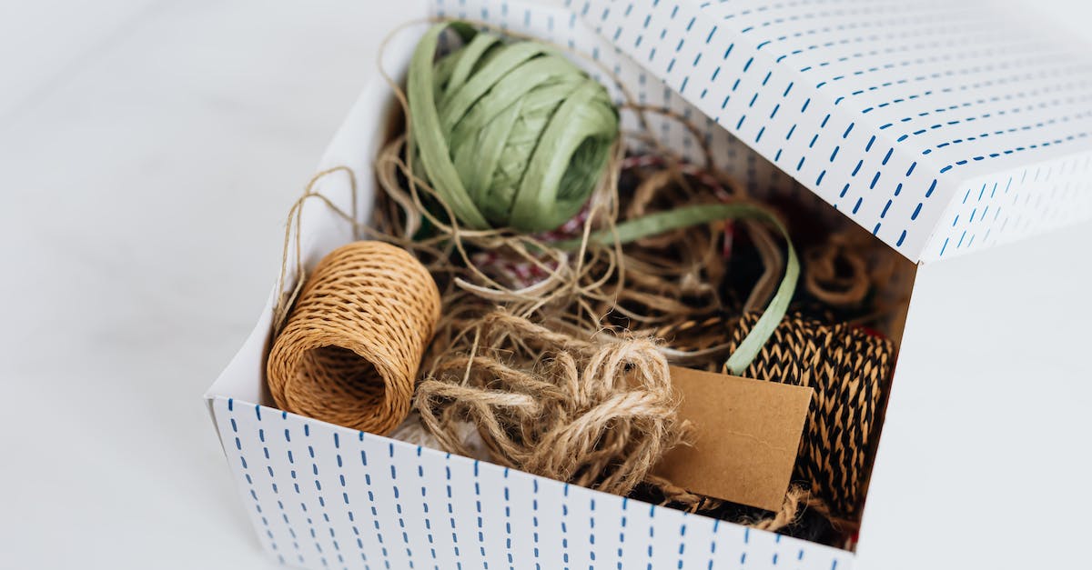 Can one receive the non-gold version of a Promo Set card from a Hearthstone pack? - From above open carton box filled with various ribbons and ropes for holiday presents and gifts wrapping and blank brown cardboard card placed on white table