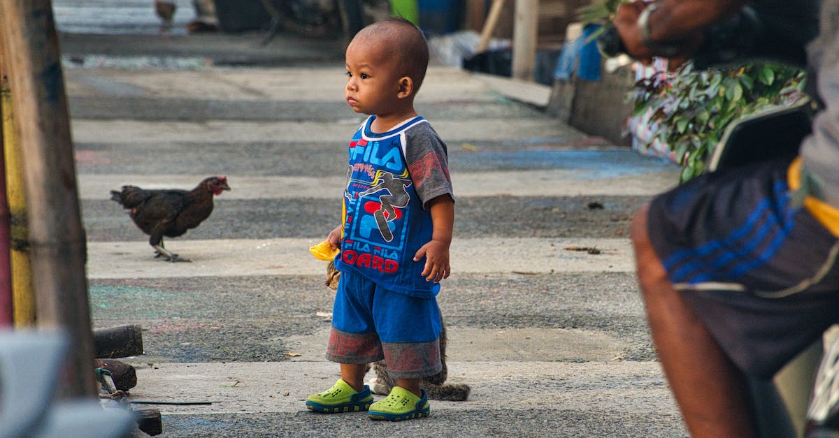Can only adopt one child? - Boy Standing Beside Cat on Roadside Can only adopt one child? - Boy Standing Beside Cat on Roadside