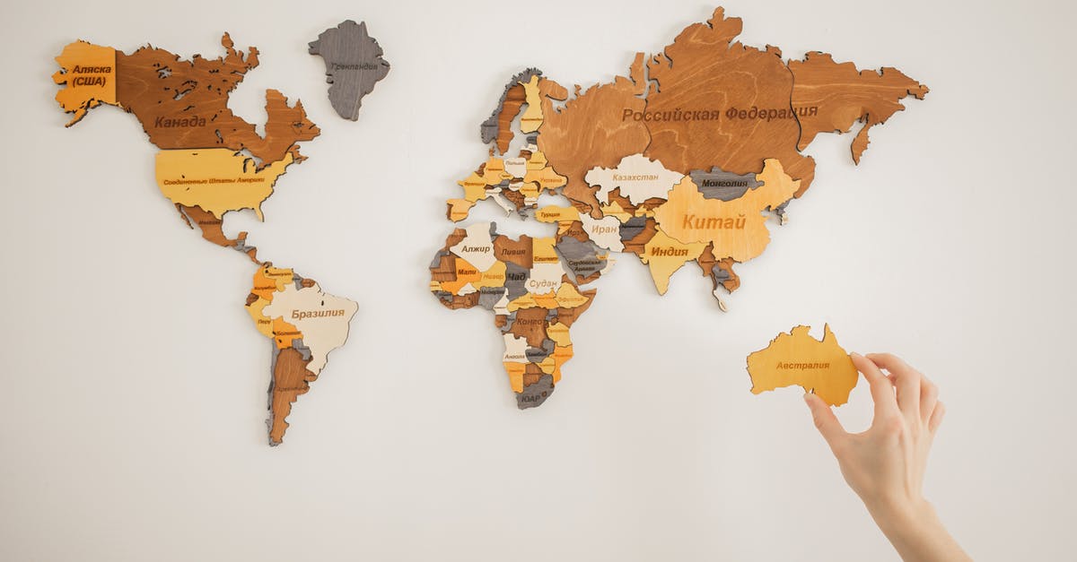 Can people change their name to my previous name? - Unrecognizable person attaching world map on wall