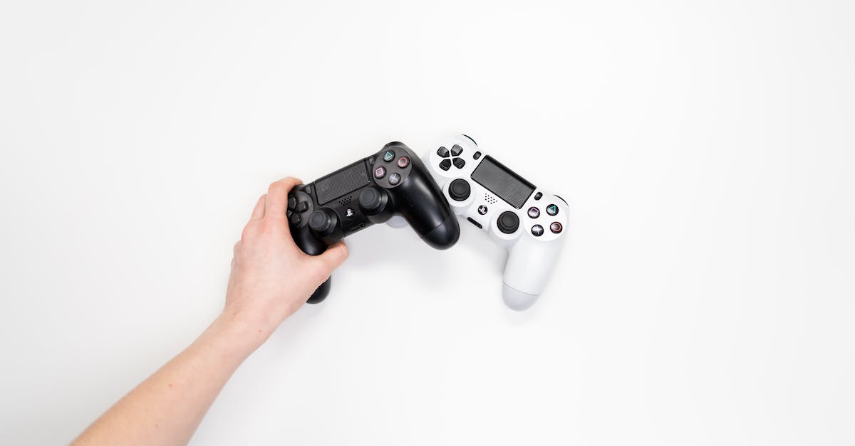 Can retail Xbox One and PlayStation 4 game disks be &ldquo;upgraded&rdquo; to digital? - Person Holding Black and Silver Ps 4 Game Controller