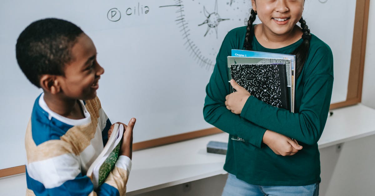 Can someone explain how do you stack Yasuo's E? - High angle of positive multiracial classmates standing near whiteboard with stack of books and answering question during lesson Can someone explain how do you stack Yasuo's E? - High angle of positive multiracial classmates standing near whiteboard with stack of books and answering question during lesson