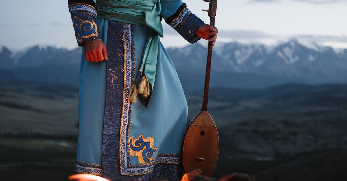 Can someone with AoE II: HD edition play multiplayer with someone who has AoE II: definitive edition? - Crop person standing near bonfire with Mongolian folk instrument in valley