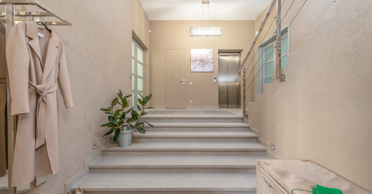 Can the entrance elevator be removed? - Lobby of contemporary apartment in beige color Can the entrance elevator be removed? - Lobby of contemporary apartment in beige color