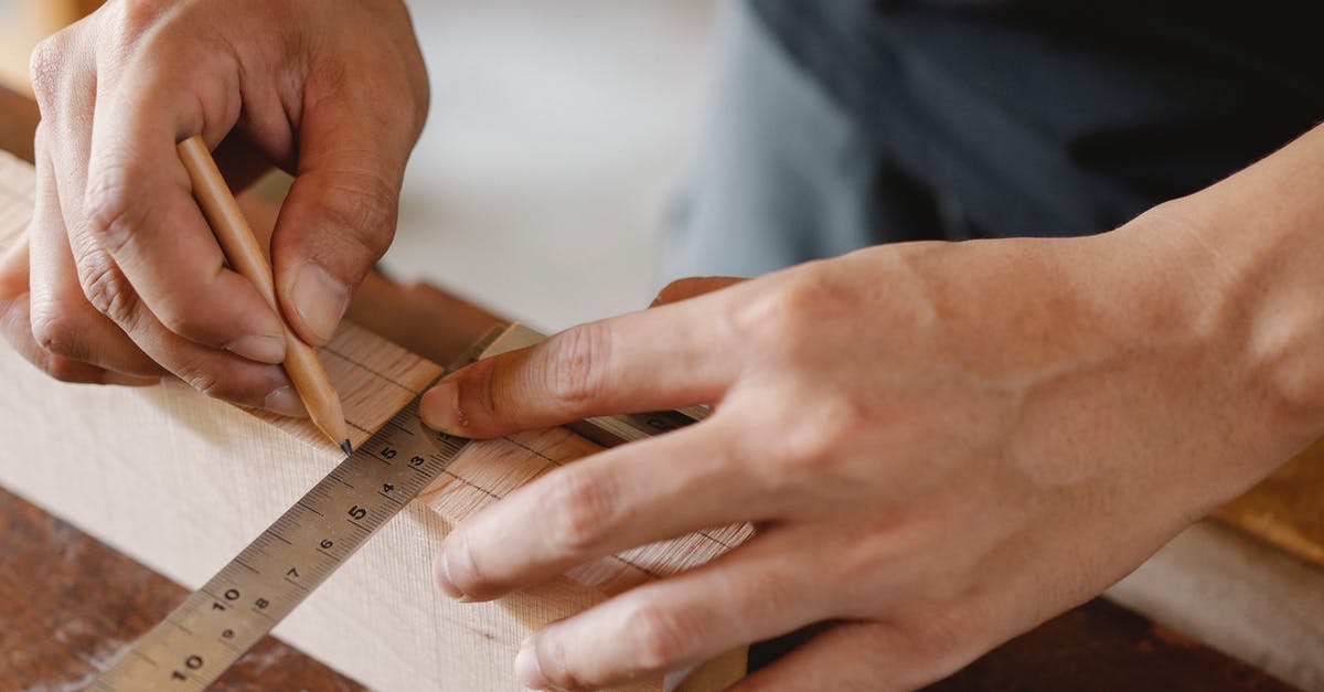 Can the mark tool be used to mark all scrap for ease of looting? - Man working with equipment on table in carpentry shop
