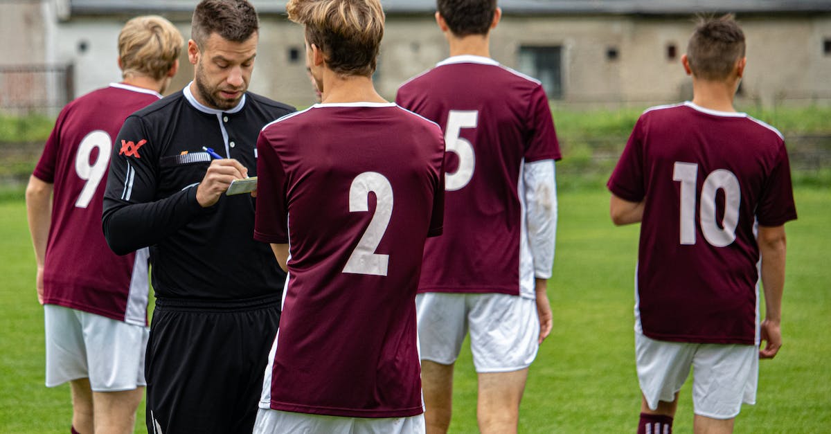 Can the players see the enemy in CounterStrike? - 2 Men in Red and White Nike Jersey Shirt Standing on Green Grass Field
