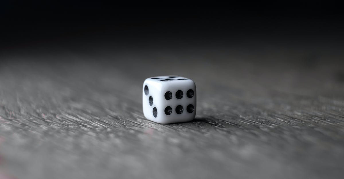 Can the Success Chance be cheesed? - Small white dice placed on wooden table