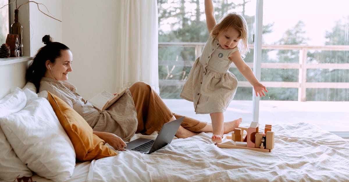 Can two consoles play on one online-enabled copy of a game - Mother and daughter using resting in bedroom with laptop and toy Can two consoles play on one online-enabled copy of a game - Mother and daughter using resting in bedroom with laptop and toy