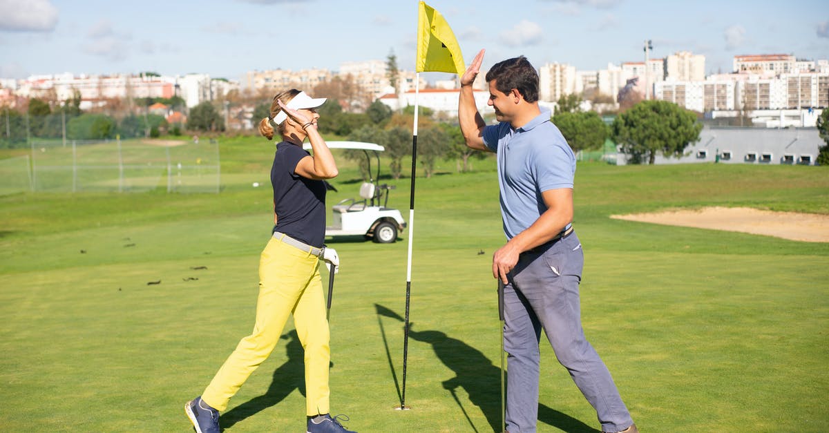 Can two people play each other's shared Steam games? - A Man and Woman Doing High Five while Standing on the Field