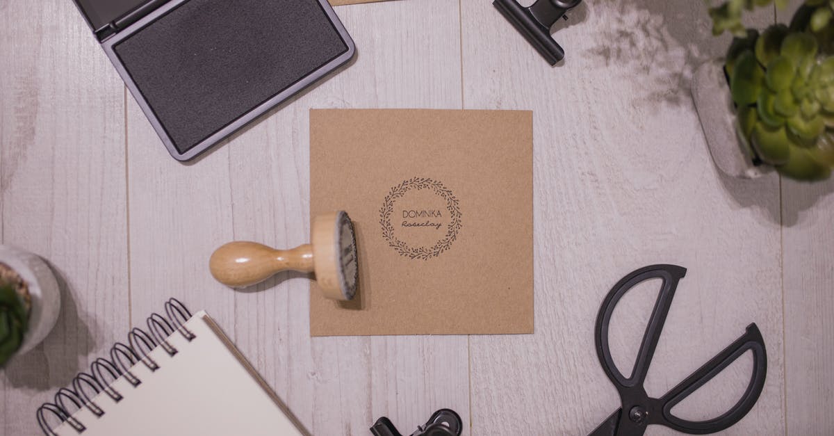 Can we craft multiple traits on a single item? - Top view of traditional rubber stamp and ink pad placed on wooden table near spiral notepad and composed with stationery and potted plants