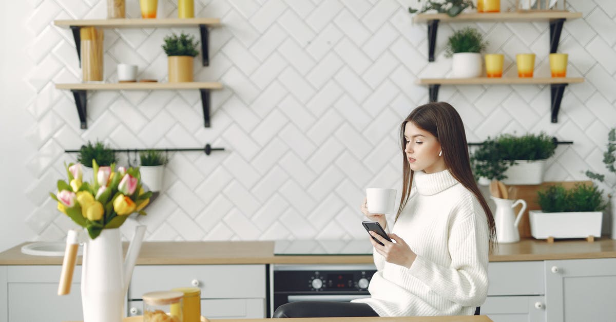 Can we record Call of Duty: Online gameplay and replay it? - Side view of focused young woman in warm sweater browsing mobile phone in cozy kitchen and drinking hot beverage while resting at table with bouquet of tulips in kitchen Can we record Call of Duty: Online gameplay and replay it? - Side view of focused young woman in warm sweater browsing mobile phone in cozy kitchen and drinking hot beverage while resting at table with bouquet of tulips in kitchen