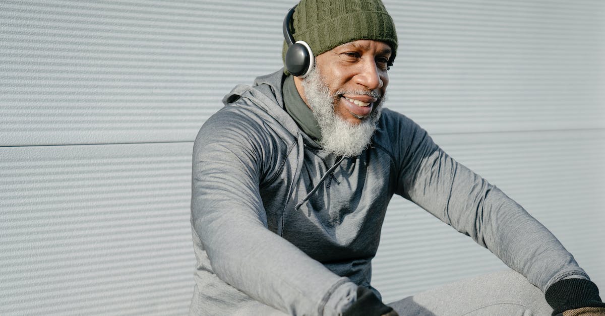 Can you add an old active account to a new device that has an active account already - Smiling elderly black man in warm clothes sitting with headphones Can you add an old active account to a new device that has an active account already - Smiling elderly black man in warm clothes sitting with headphones
