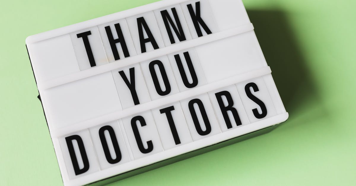 Can you change teams? - From above of vintage light box with THANK YOU DOCTORS gratitude message placed on green surface