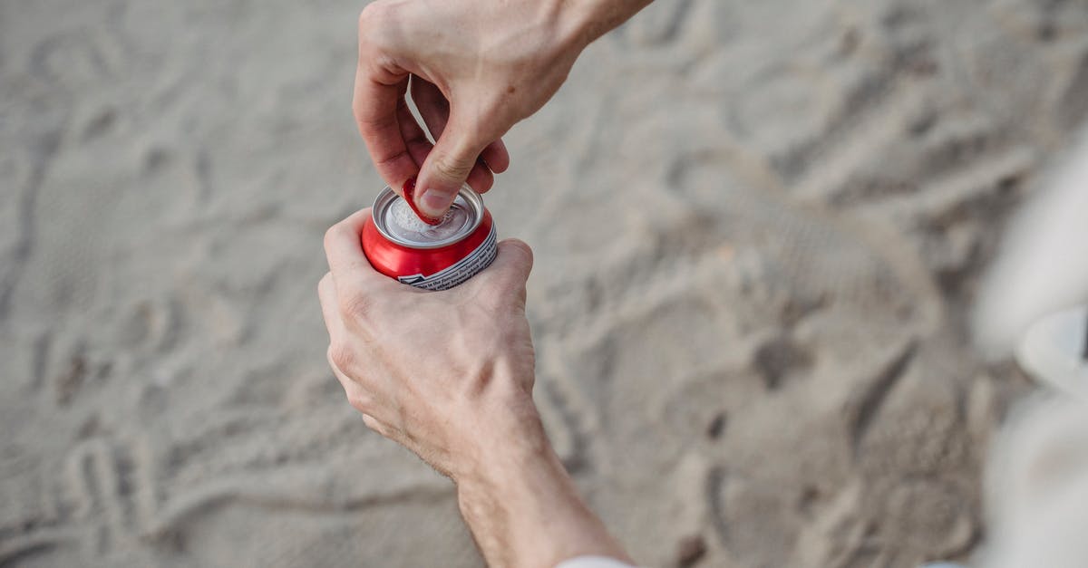 Can you Fulton enemy characters multiple times? - From above of crop anonymous male opening can of drink standing on sandy beach Can you Fulton enemy characters multiple times? - From above of crop anonymous male opening can of drink standing on sandy beach