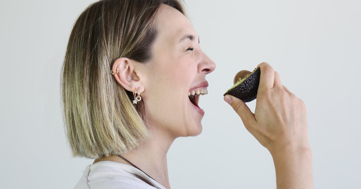 Can you get the Minecraft seed on xbox? - Woman Holding a Sliced Avocado near Mouth