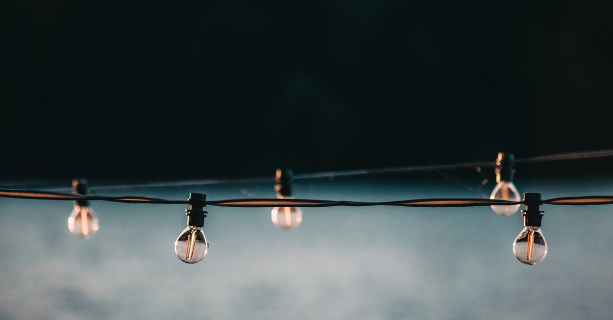Can you increase your energy above maximum? - Small switched off electric lamps on long wire strained above gray blurred surface Can you increase your energy above maximum? - Small switched off electric lamps on long wire strained above gray blurred surface