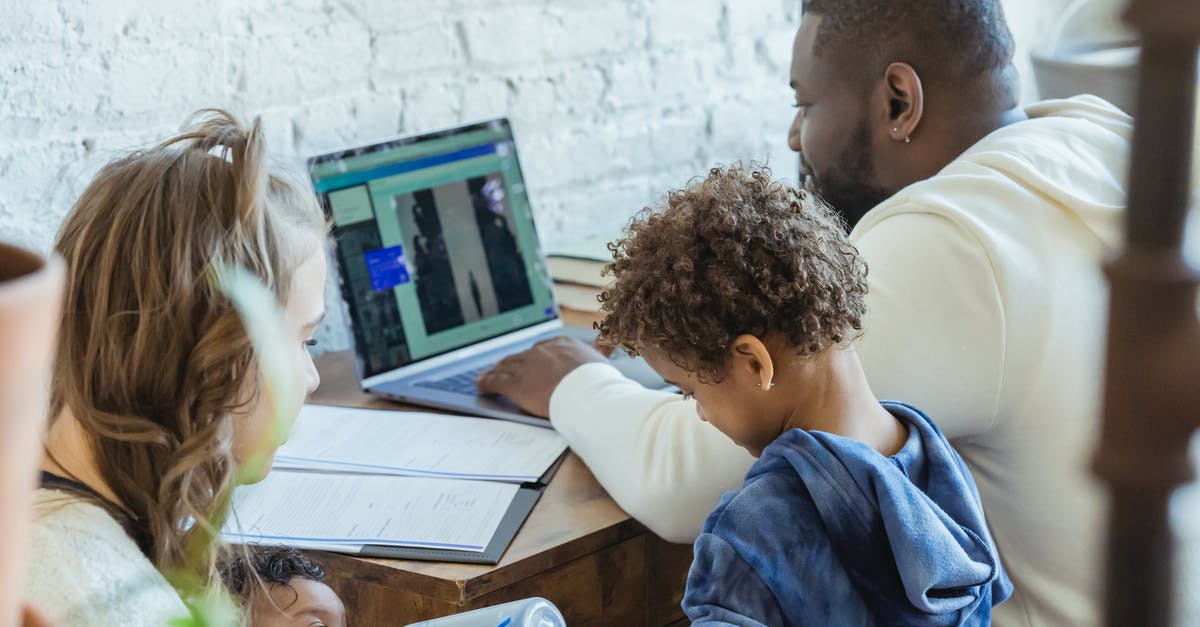 Can you let computer play your character when you are away from the keyboard? - High angle of African American dad watching laptop working near son playing toys and mother feeding little infant Can you let computer play your character when you are away from the keyboard? - High angle of African American dad watching laptop working near son playing toys and mother feeding little infant