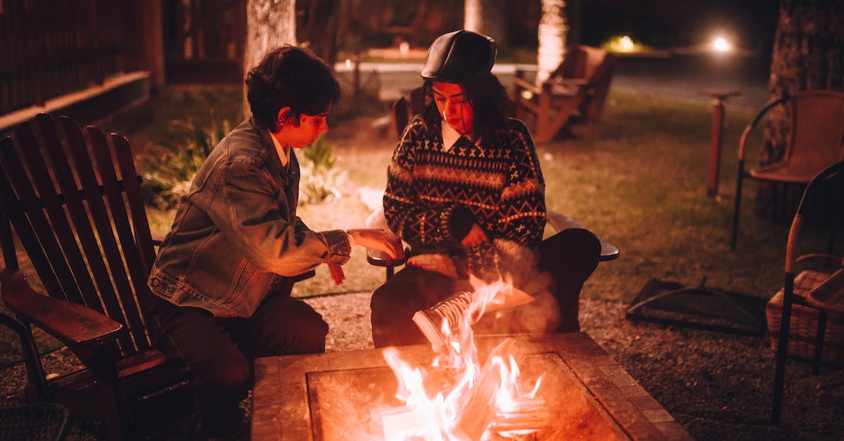 Can you lower a bonfire intensity after burning a bonfire ascetic? - Boy and Girl Sitting Next to a Bonfire 