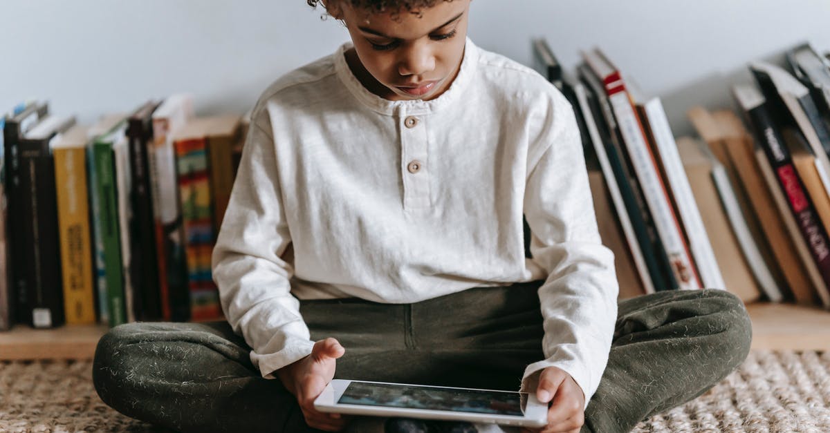 Can you play online with a game bought on a none online subscription account in Switch? - Crop black boy browsing tablet in room