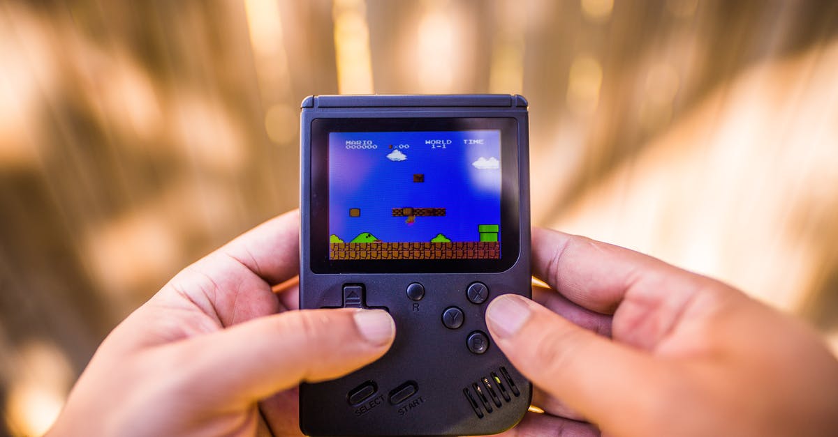 Can you put SNES roms on a Super Mario Bros Game & Watch? - Shallow Focus Photo of Gameboy Console