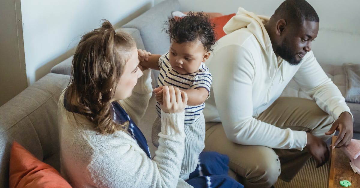 Can you remove a mom and dad from the living quarters once the mom is pregnant? - Cheerful multiethnic family spending time on sofa at home Can you remove a mom and dad from the living quarters once the mom is pregnant? - Cheerful multiethnic family spending time on sofa at home