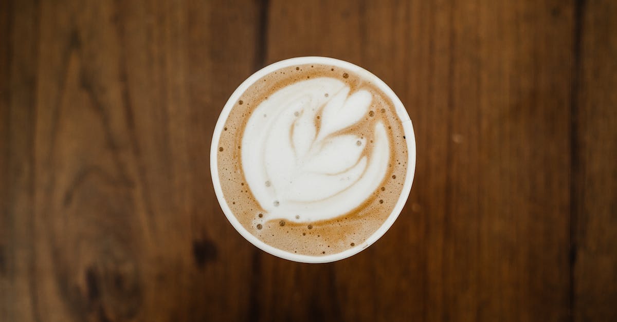Can you still combo break an opponent's move with no life bar? - Top view of cup of aromatic cappuccino in ceramic cup with white foam poured in form of plant on brown surface