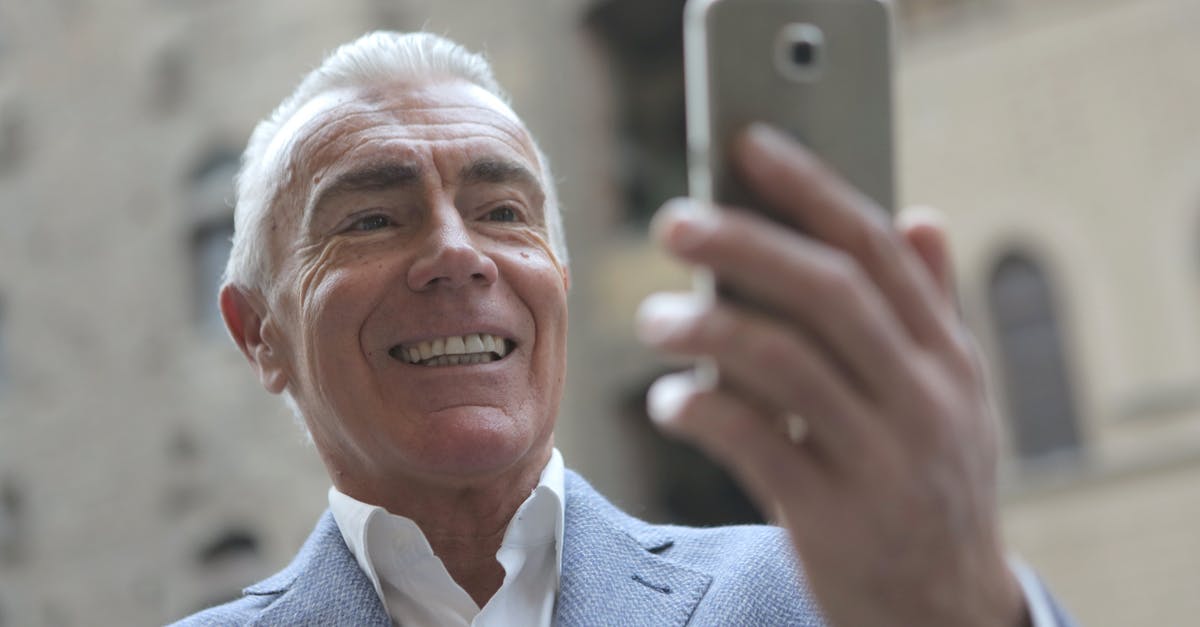 Can you take pictures in the Wii U of YOURSELF like in the 3DS, not just Mii's Face - Man in Gray Suit Jacket Holding Smartphone Can you take pictures in the Wii U of YOURSELF like in the 3DS, not just Mii's Face - Man in Gray Suit Jacket Holding Smartphone