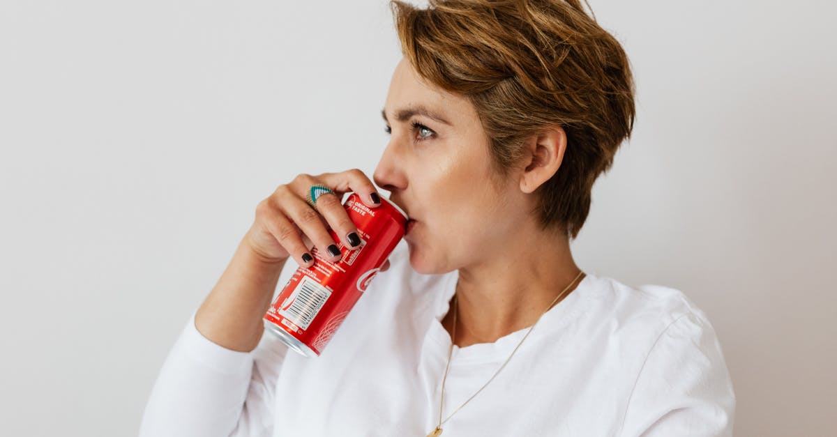Can you trade from Pokemon Red on GBA to Pokemon gold on virtual console? - Pensive female in white wear with gold necklace and ring on finger drinking cold coke from red can and looking away