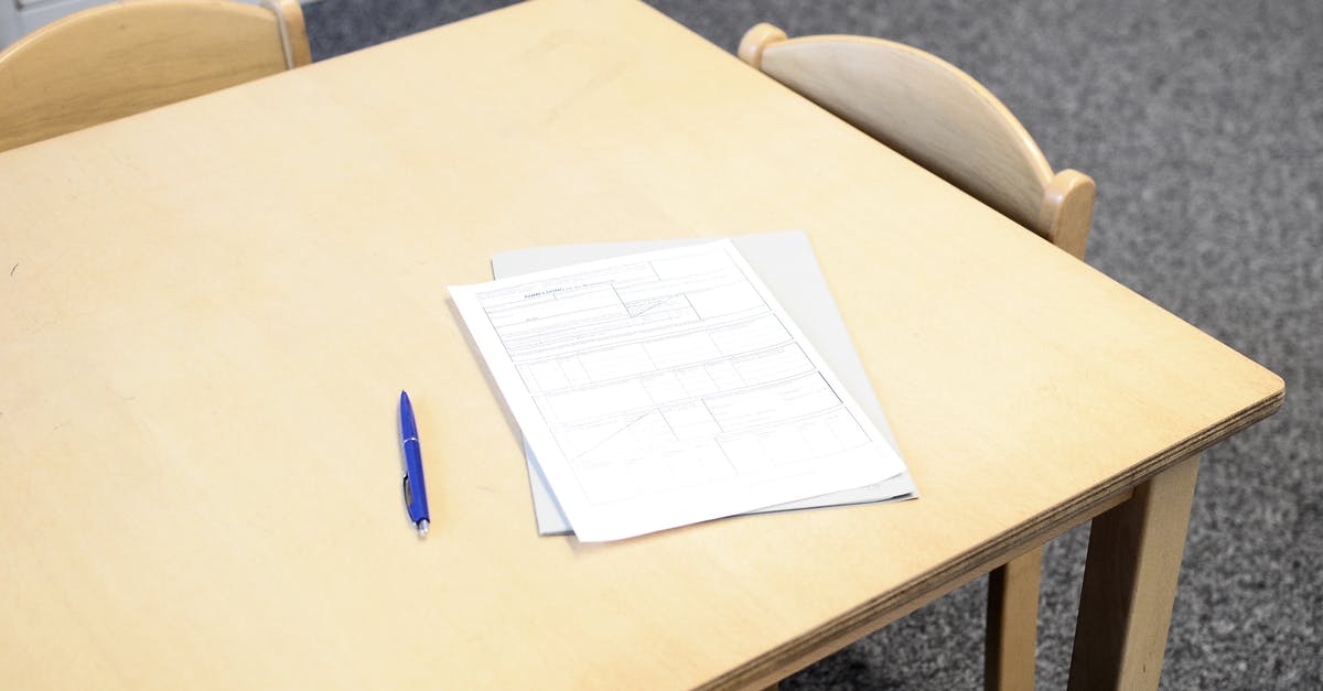 Cannot assign dweller to empty room - Papers with pen on table in classroom