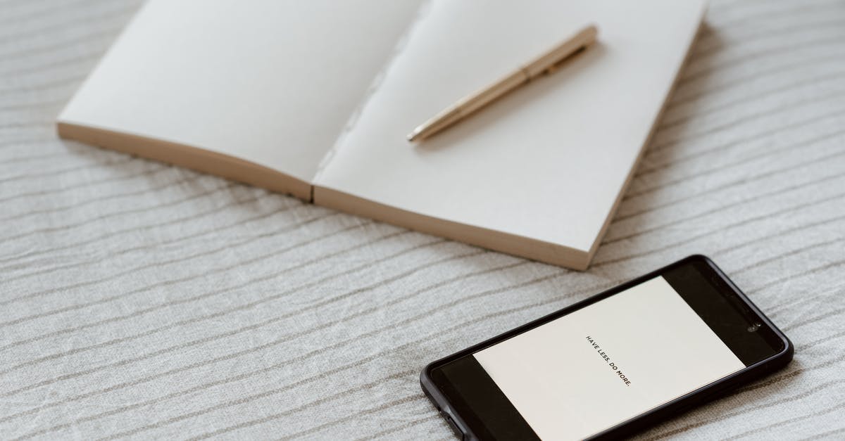 Cannot get to the title screen - Smartphone near empty notebook with pen on bed