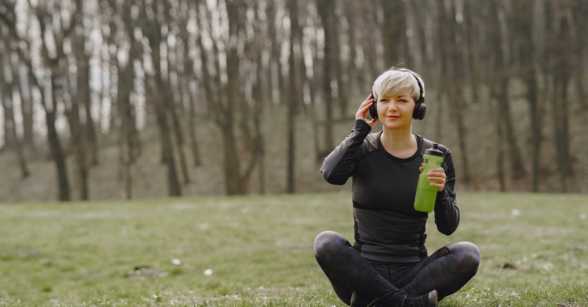 Cannot power on Xbox One from Smartglass or W10 app - Young fit woman in headphones sitting on ground holding bottle of water and listening to music Cannot power on Xbox One from Smartglass or W10 app - Young fit woman in headphones sitting on ground holding bottle of water and listening to music