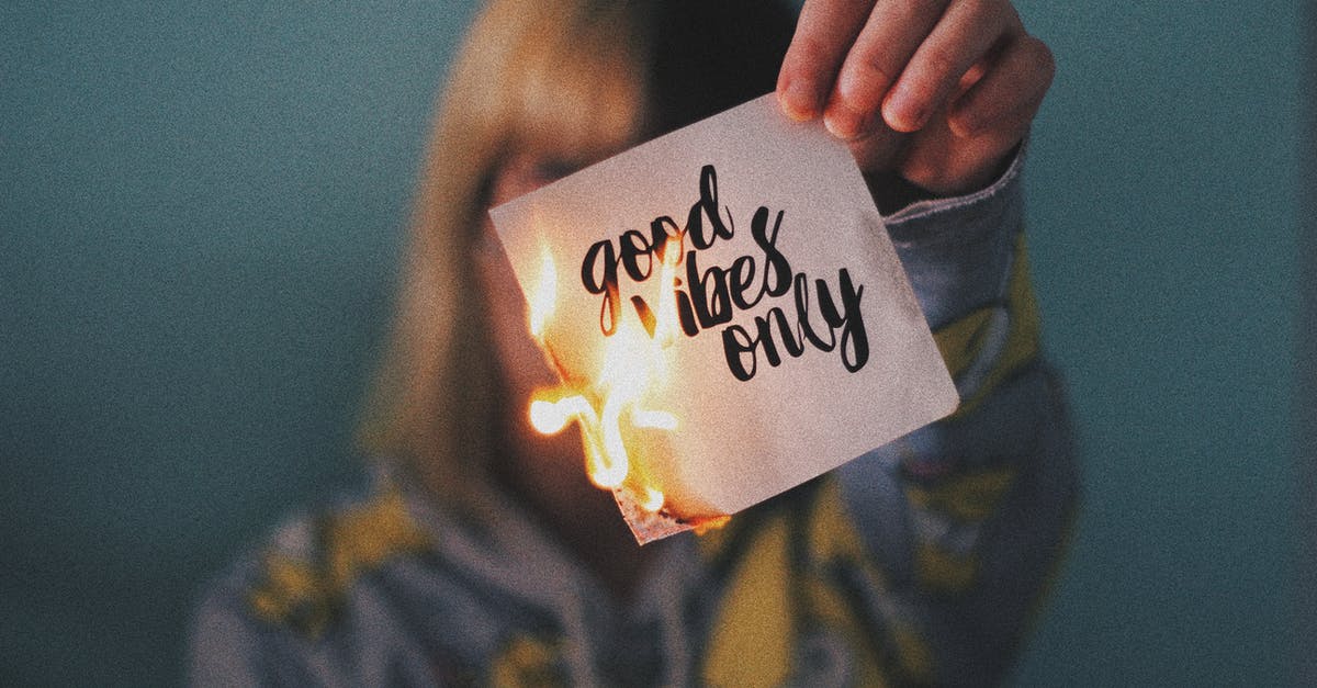 Cannot use Rapid fire button with RMB - Unrecognizable female showing burning paper with written inscription and bright flame on blurred background Cannot use Rapid fire button with RMB - Unrecognizable female showing burning paper with written inscription and bright flame on blurred background