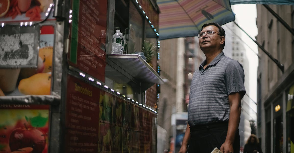 Casual veersus competetive dedicated servers in Counter Strike: GO - Low angle of pensive male in glasses and casual clothes standing near truck with street food and choosing meal Casual veersus competetive dedicated servers in Counter Strike: GO - Low angle of pensive male in glasses and casual clothes standing near truck with street food and choosing meal