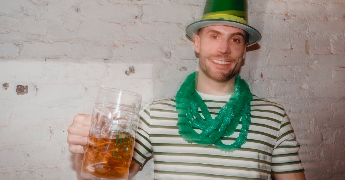 Celestial event won't initiate after killing the Lunatic Cultist - Through glass wall view of smiling male in shamrock hat looking at camera with jar of beer during Feast of Saint Patrick
