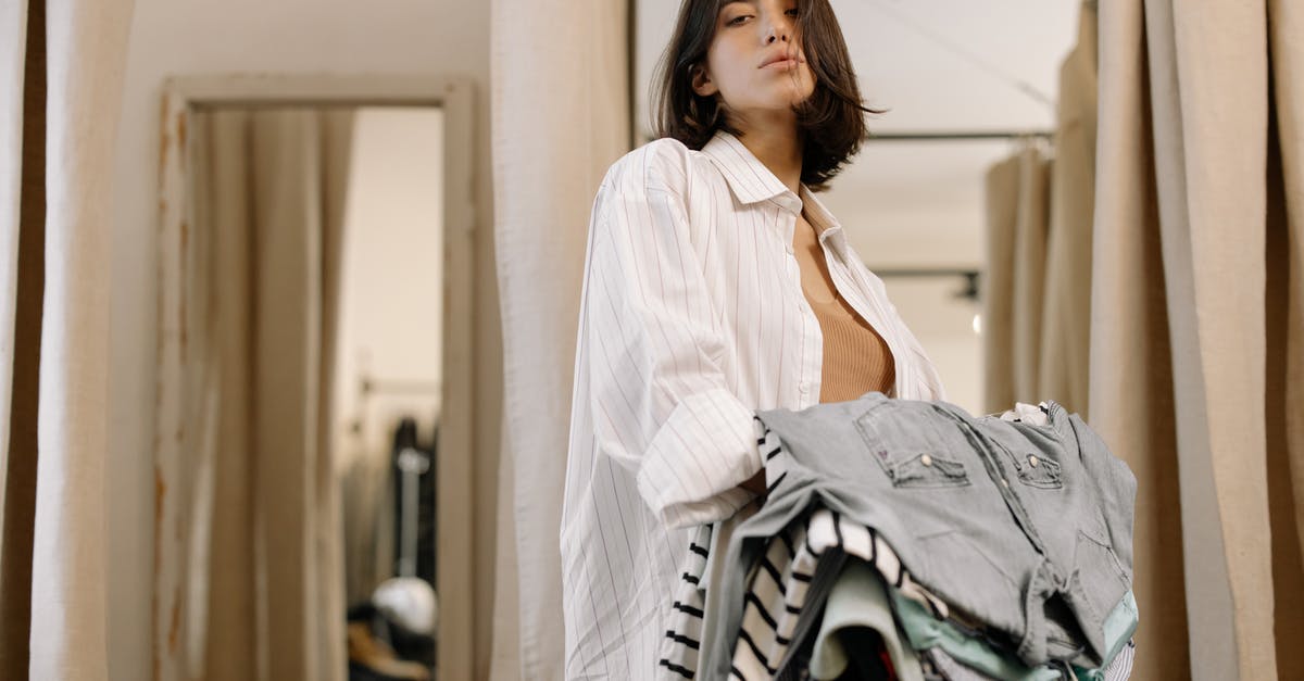 Change AI clothing selection - Woman in White Long Sleeve Shirt Holding Clothes Change AI clothing selection - Woman in White Long Sleeve Shirt Holding Clothes