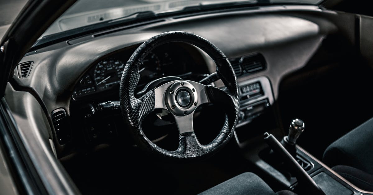 Change from Automatic to Manual transmission in Forza Horizon 5? - From above of black interior of aged automobile with steering wheel and manual transmission with dashboard parked on asphalt road